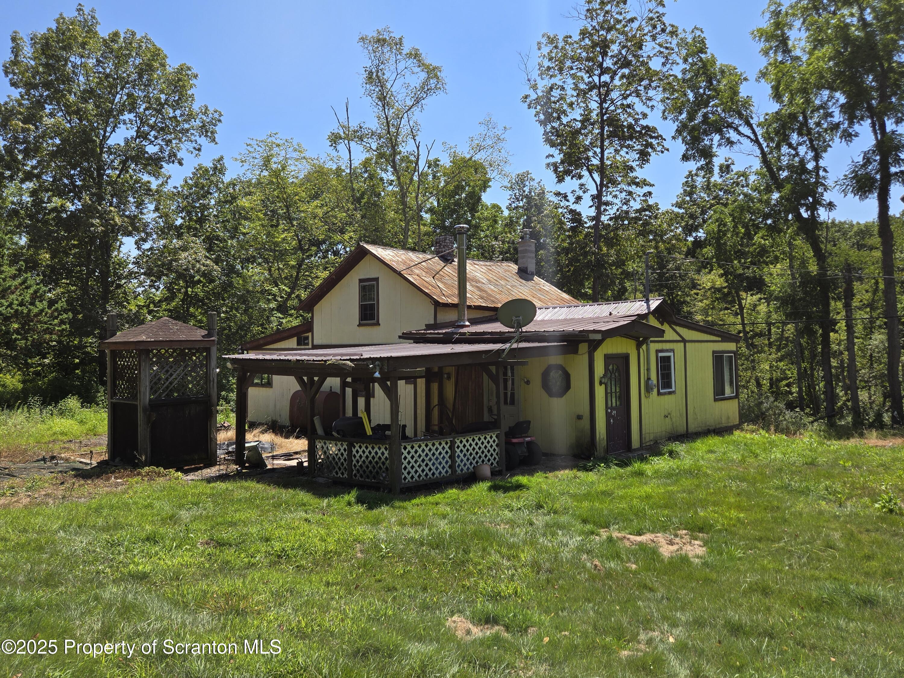 828 West Avery Station Road Tunkhannock, PA 18657 - Photo 16 of 16 a view of backyard with a garden and deck