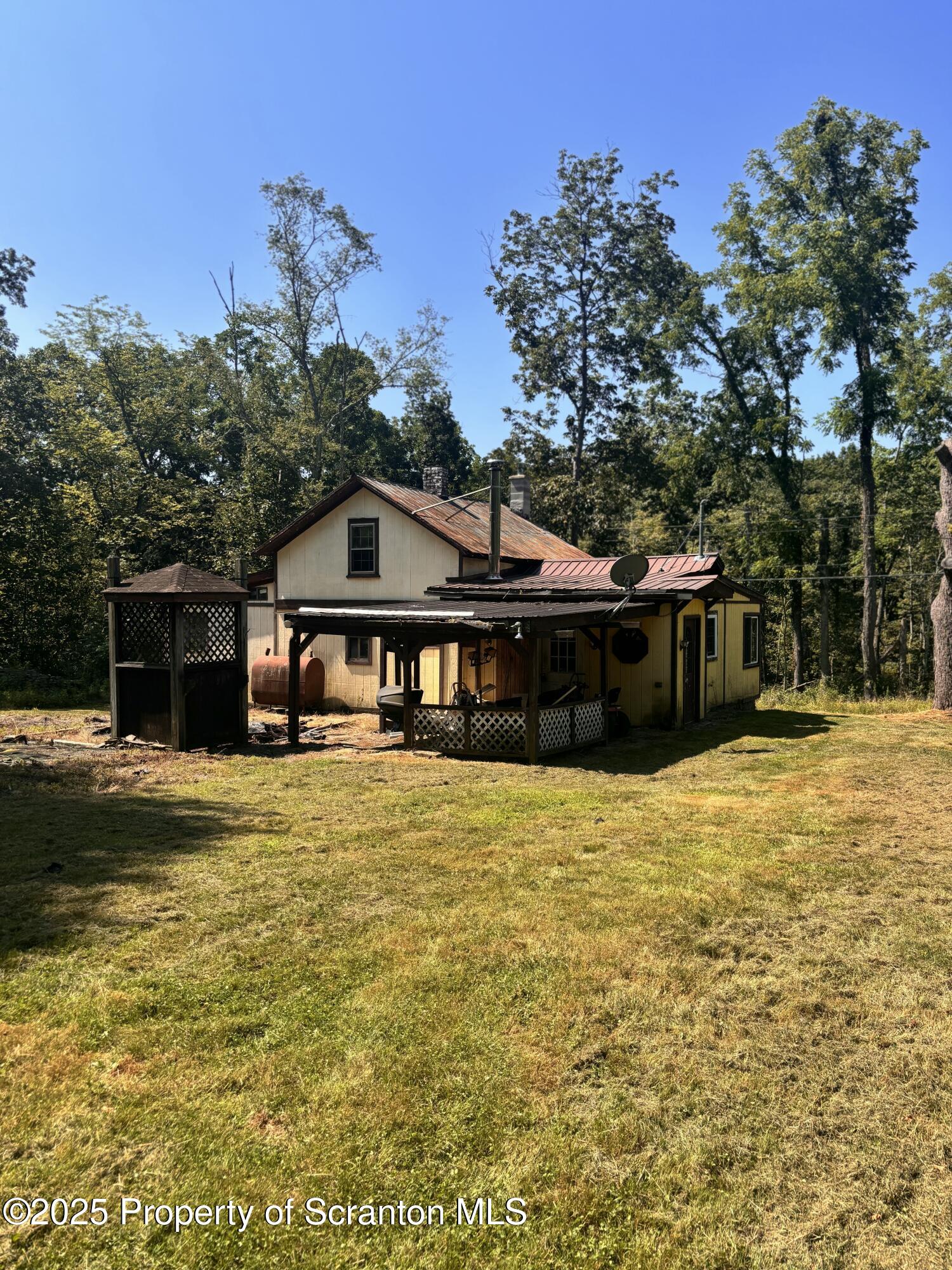 828 West Avery Station Road Tunkhannock, PA 18657 - Photo 2 of 16 a front view of a house with a garden
