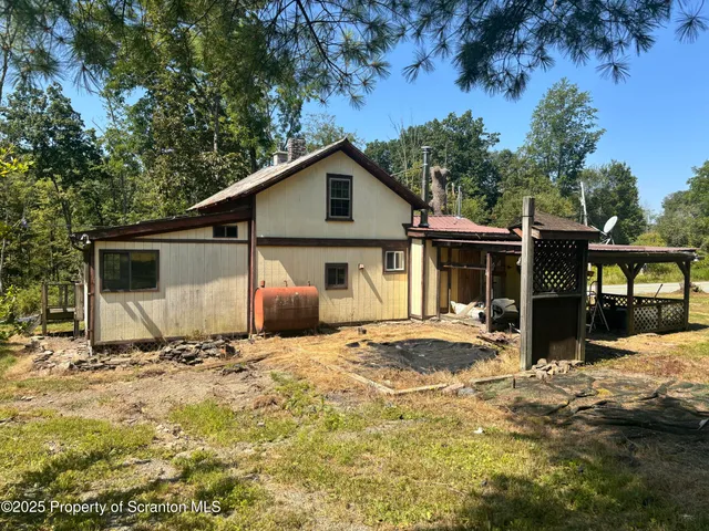 a view of a house with a yard covered in snow
