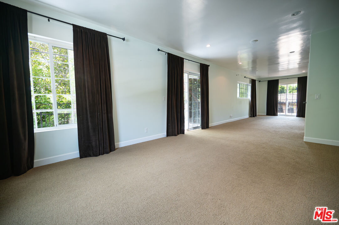 503 North Greencraig Road Los Angeles, CA 90049 - Photo 33 of 59 a view of a big room with windows and cabinet