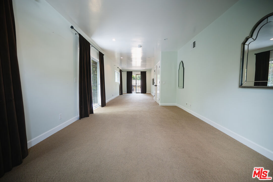 503 North Greencraig Road Los Angeles, CA 90049 - Photo 34 of 59 a view of a big room with closet and a fireplace