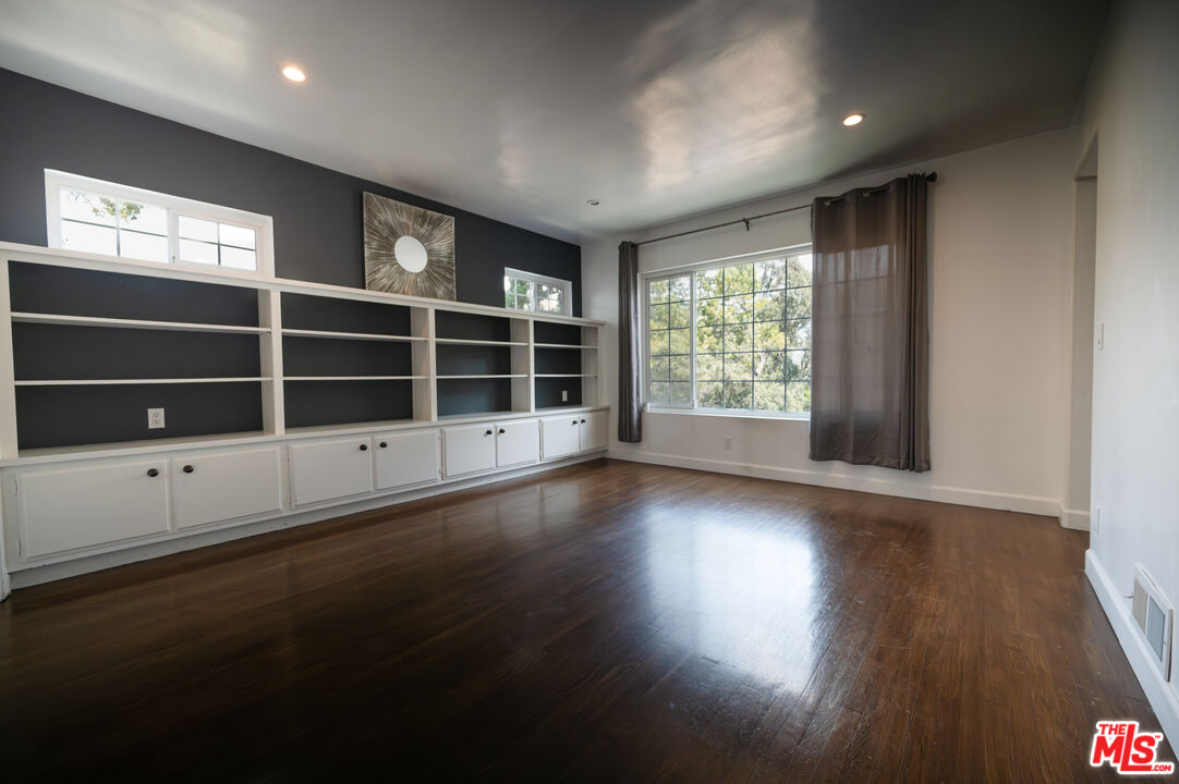 503 North Greencraig Road Los Angeles, CA 90049 - Photo 4 of 59 a view of an empty room with wooden floor and windows
