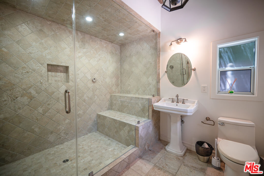 503 North Greencraig Road Los Angeles, CA 90049 - Photo 47 of 59 a bathroom with a toilet a sink and mirror