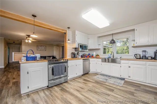 a kitchen with stainless steel appliances granite countertop a sink and cabinets