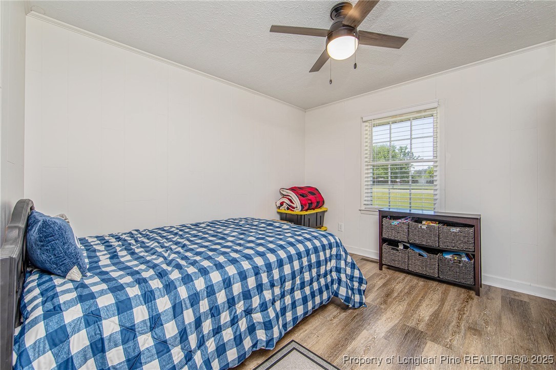 40 Kinlaw Road Lumberton, NC 28358 - Photo 43 of 50 a bedroom with a bed and a chandelier
