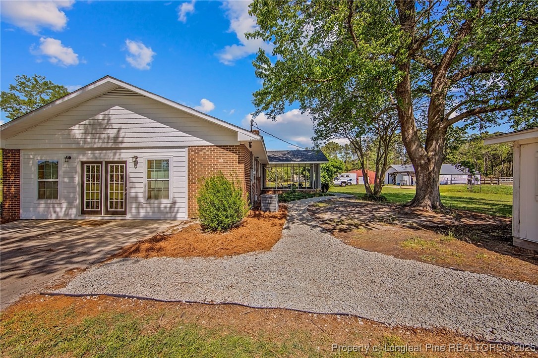 40 Kinlaw Road Lumberton, NC 28358 - Photo 6 of 50 a front view of a house with a yard and garage