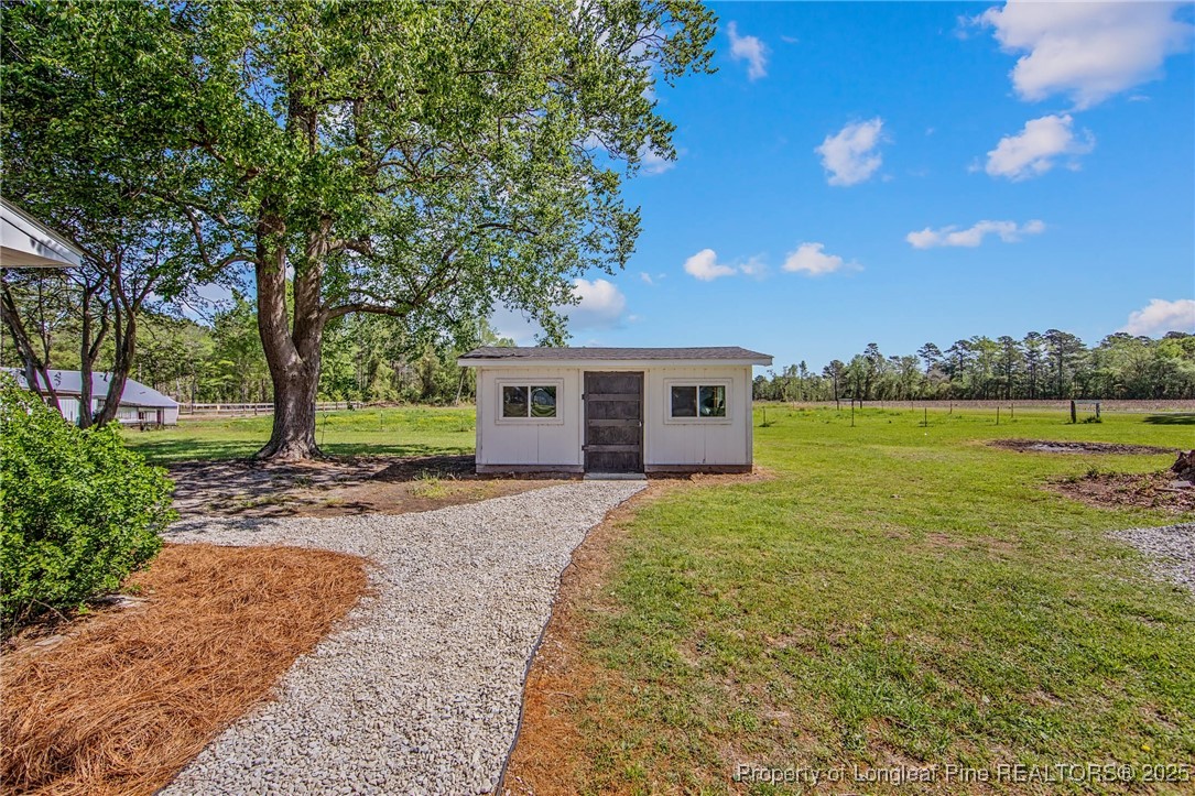 40 Kinlaw Road Lumberton, NC 28358 - Photo 9 of 50 a front view of a house with garden