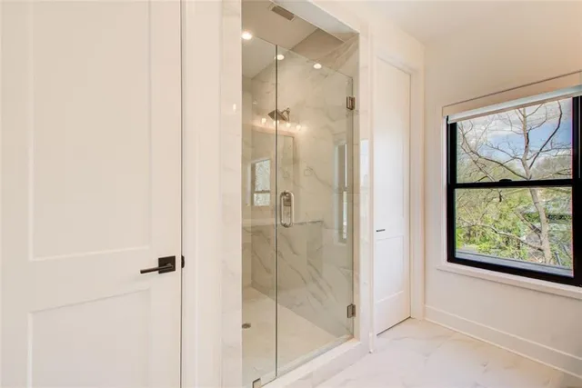a bathroom with a glass shower door