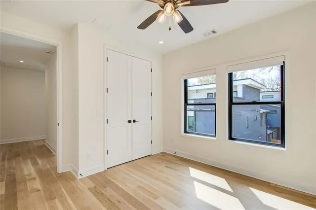 a view of an empty room with a window and closet