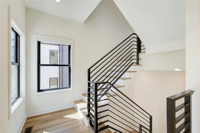 a view of entryway and hall with wooden floor