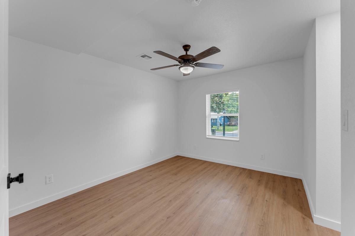 407 East Kerr Street Burnet, TX 78611 - Photo 13 of 21 an empty room with a window and a fan