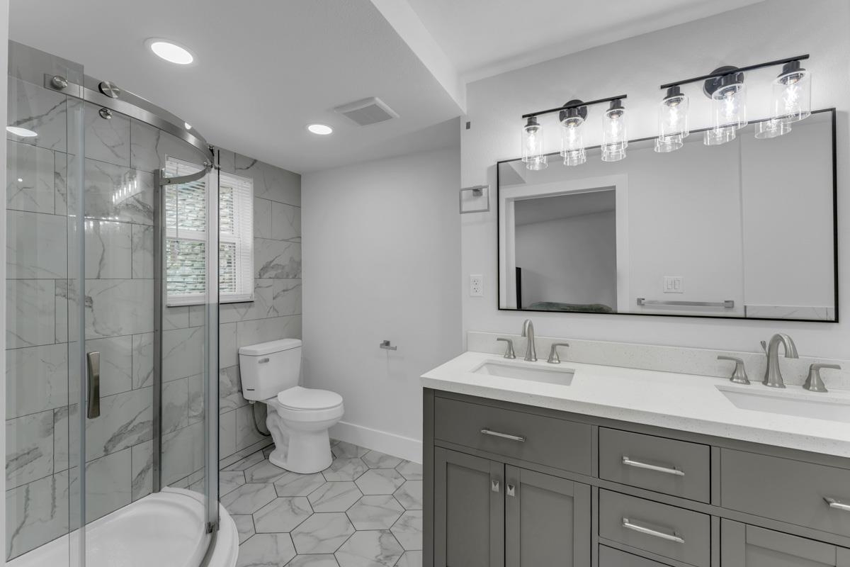 407 East Kerr Street Burnet, TX 78611 - Photo 15 of 21 a bathroom with a double vanity sink mirror and toilet