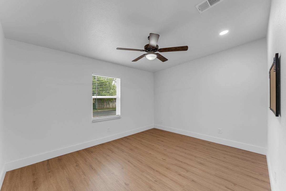407 East Kerr Street Burnet, TX 78611 - Photo 16 of 21 a view of empty room with wooden floor and fan