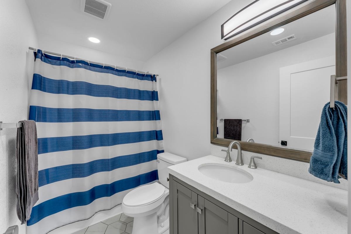 407 East Kerr Street Burnet, TX 78611 - Photo 17 of 21 a bathroom with a sink and a mirror