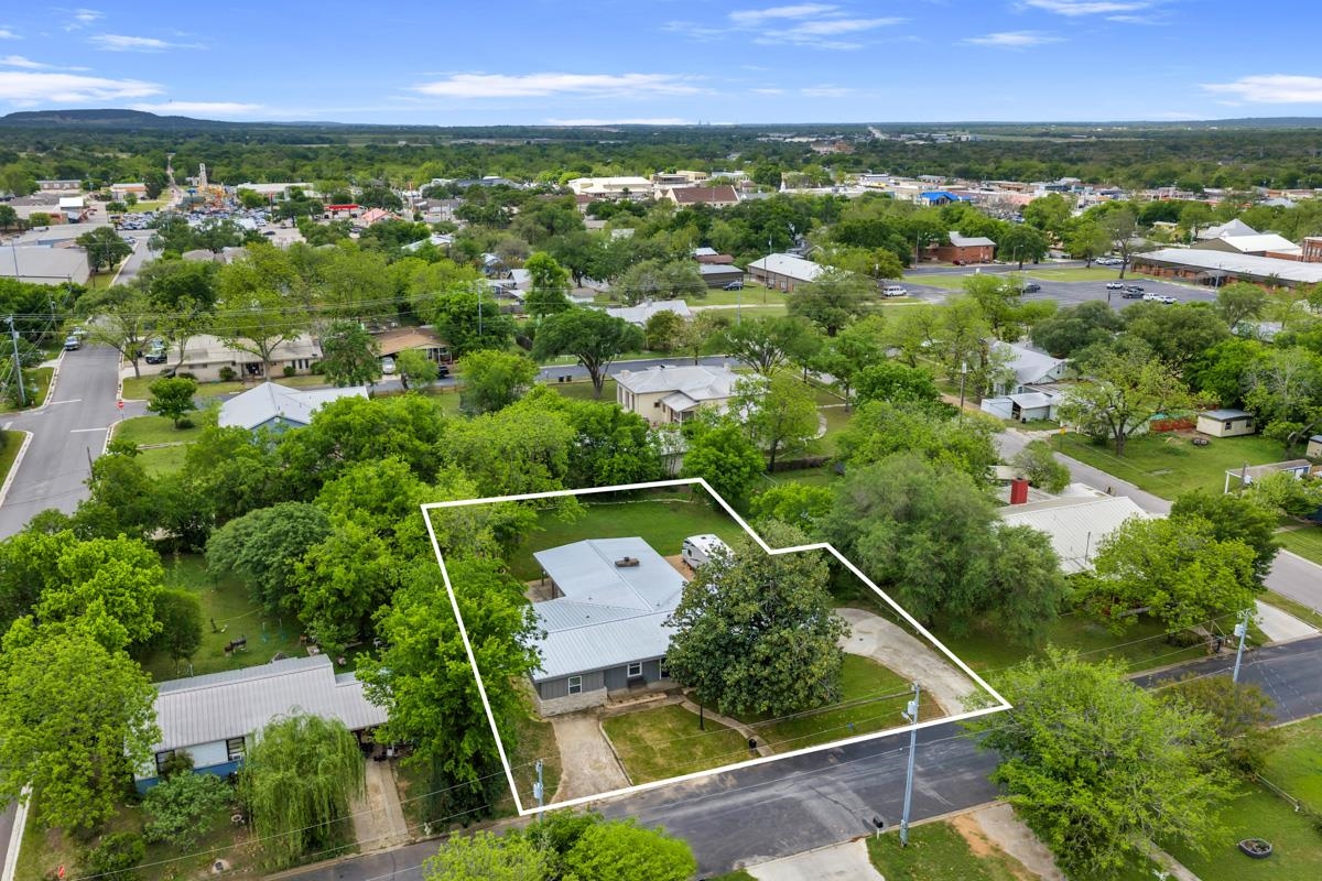 407 East Kerr Street Burnet, TX 78611 - Photo 3 of 21 an aerial view of residential houses with outdoor space and trees
