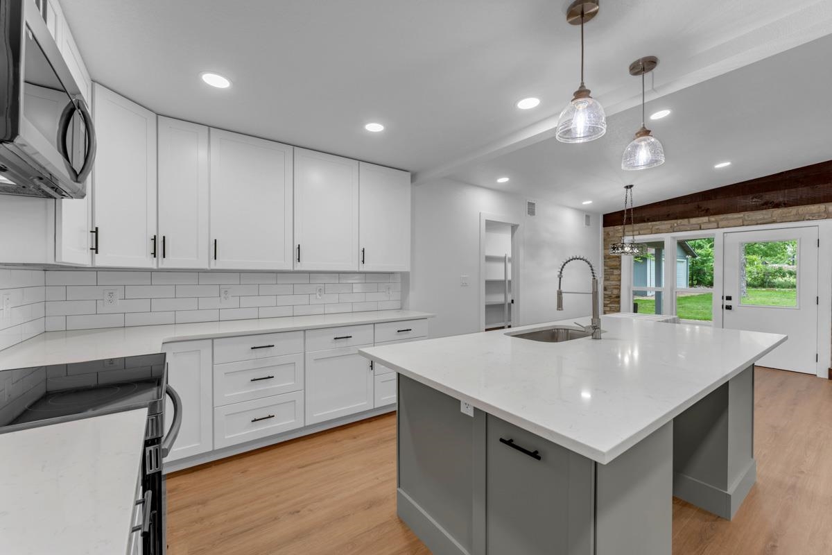 407 East Kerr Street Burnet, TX 78611 - Photo 7 of 21 a kitchen with a stove a sink and a refrigerator