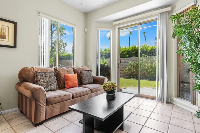 a kitchen with stainless steel appliances granite countertop a table chairs sink and cabinets