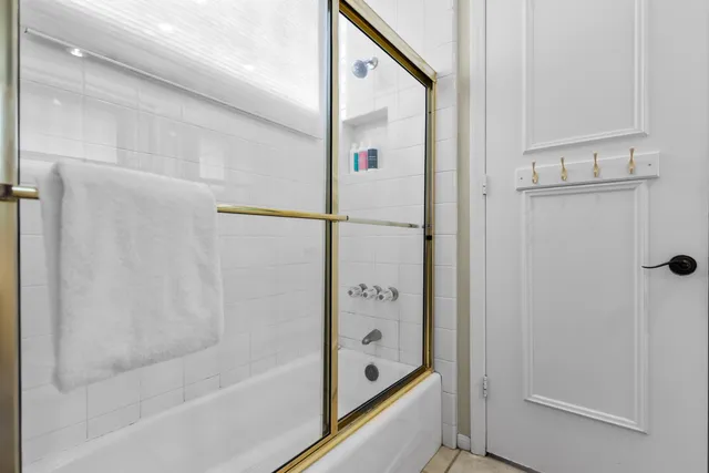 a white bath tub sitting next to a white toilet