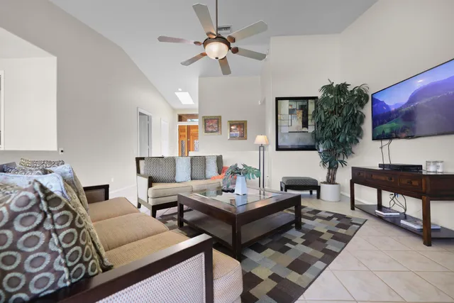 a living room with furniture a fireplace and a large window