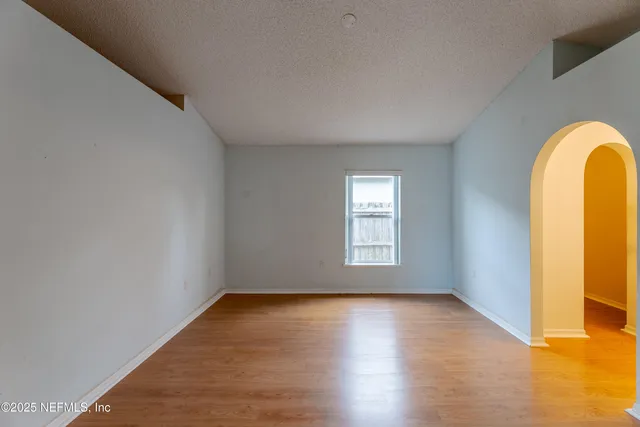 a view of a room with wooden floor and a window