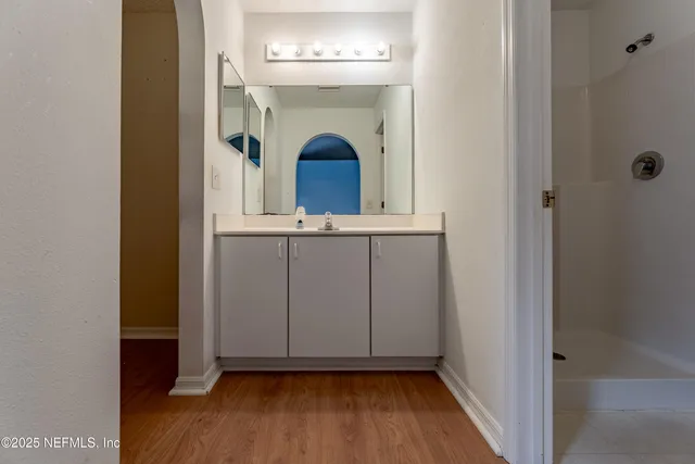 a view of a hallway with wooden floor and staircase