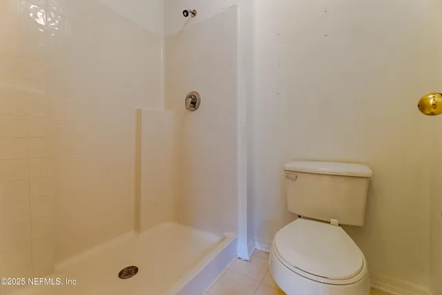 a white toilet sitting next to a bath tub