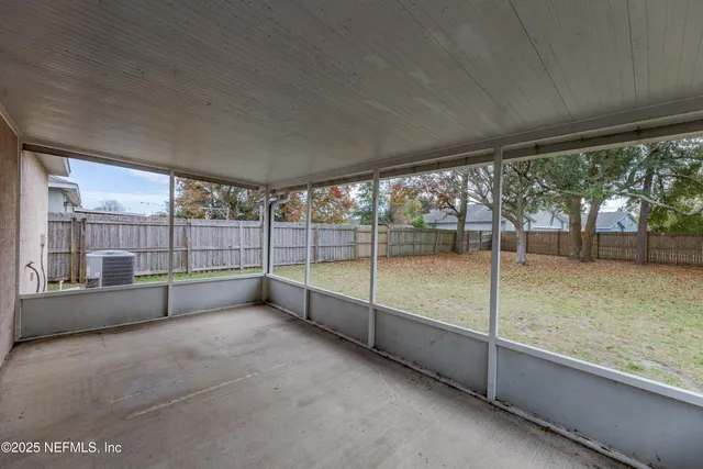 a view of an empty room with sliding glass door and mountain view