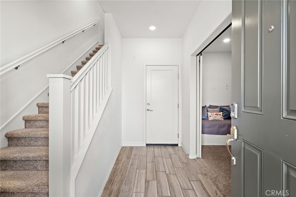 144 Paramount Irvine, CA 92618 - Photo 22 of 43 a view of a hallway view with wooden floor and staircase