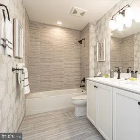 a bathroom with a sink a toilet and bathtub