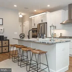 a kitchen with stainless steel appliances granite countertop a sink and cabinets