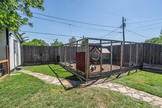 a view of a backyard with wooden fence