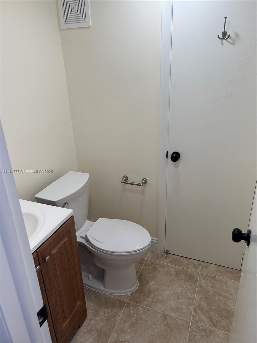 1051 Southwest 1st Street, Unit 404 Miami, FL 33130 - Photo 16 of 37 a white toilet sitting next to a white sink