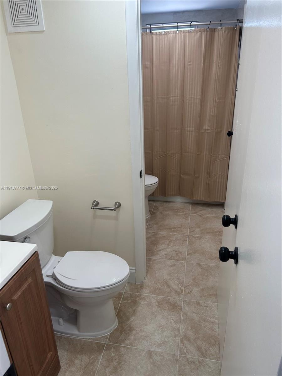 1051 Southwest 1st Street, Unit 404 Miami, FL 33130 - Photo 17 of 37 a bathroom with a toilet and a shower