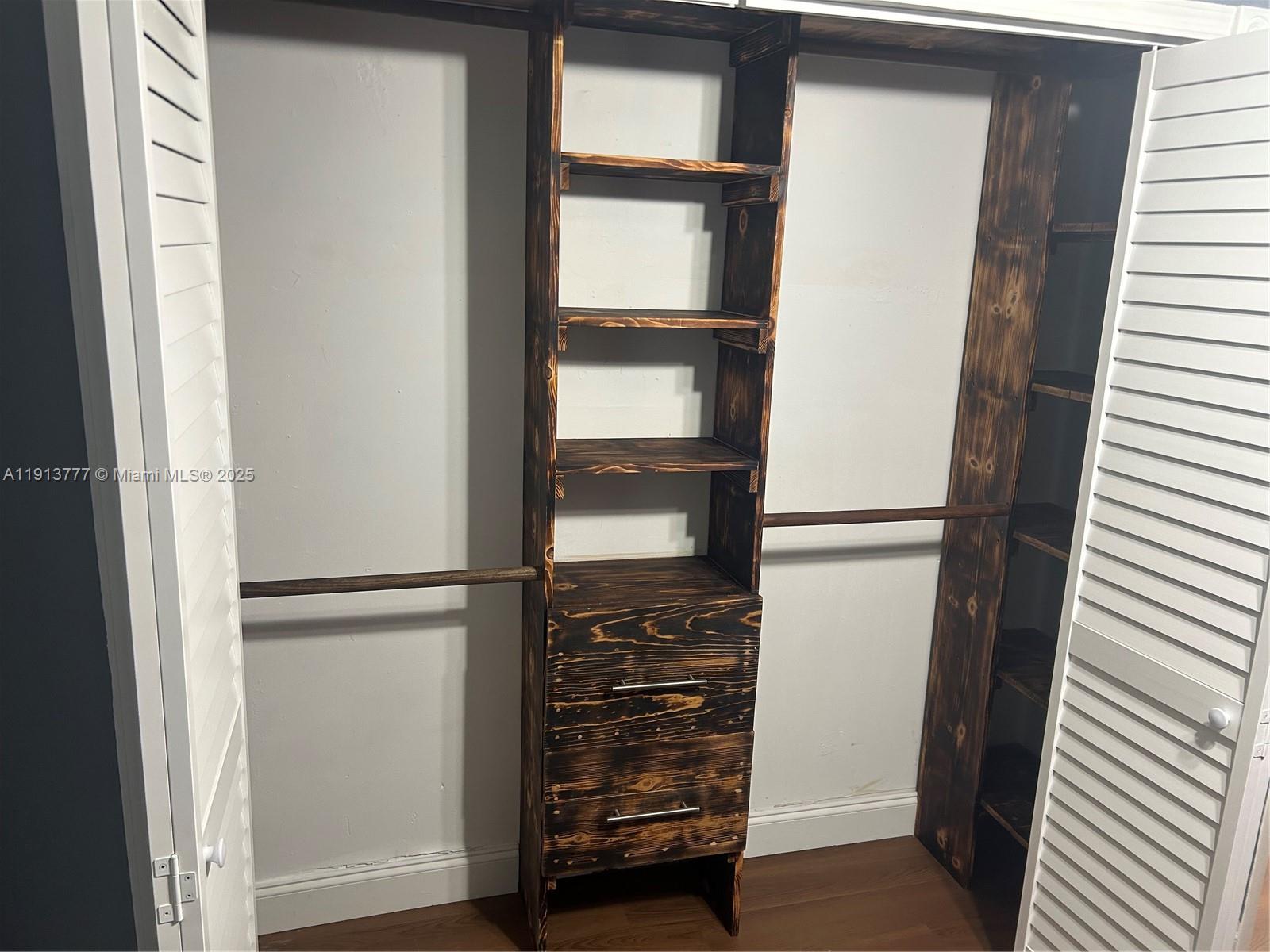 1051 Southwest 1st Street, Unit 404 Miami, FL 33130 - Photo 26 of 37 a view of walk in closet with empty racks