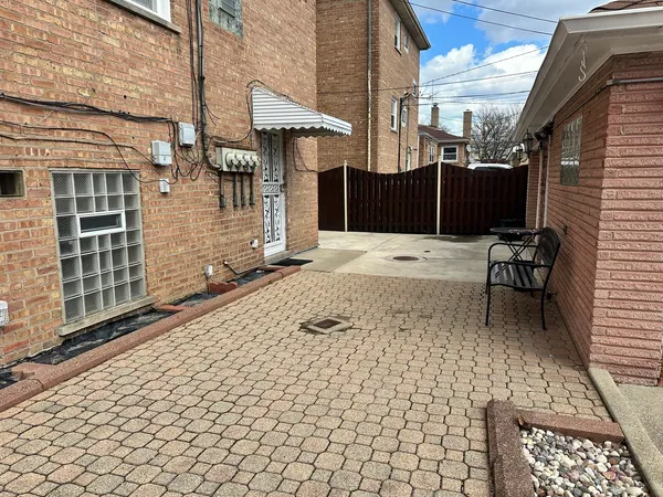 a backyard of a house with barbeque oven