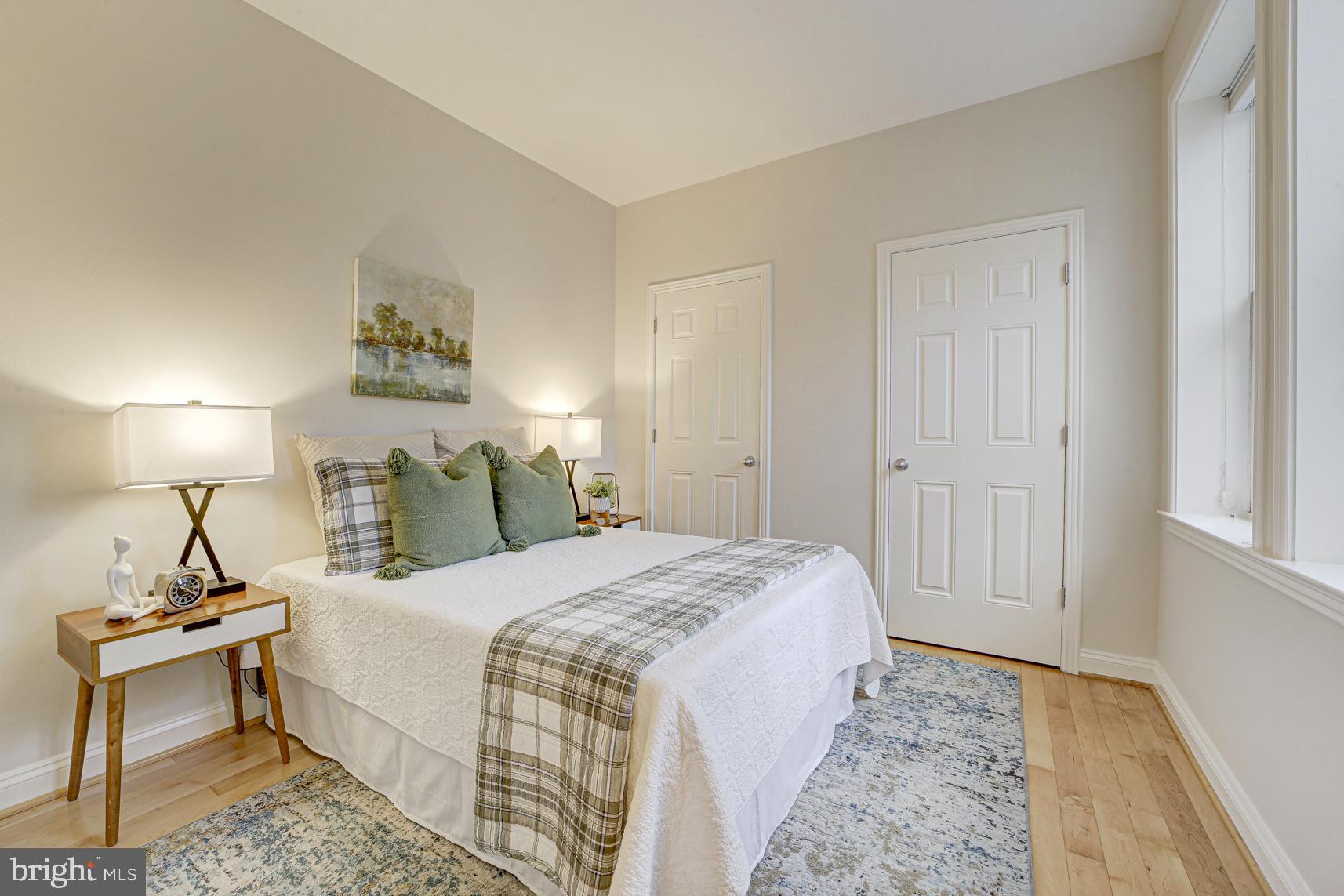 220 13th Street Southeast, Unit 24 Washington, DC 20003 - Photo 19 of 27 a bedroom with a bed and a table