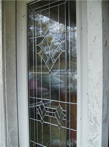 Leaded glass entry leads to 19x15 Living Room.  A fireplace in left rear corner. Beadboard ceilings, hardwood floors, just needs paint in front room to finish.