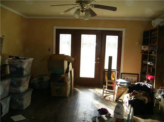 1246 Cochran Cemetery Road Lewisburg, TN 37091 - Photo 10 of 20 Excuse the boxes and mess, owner is trying to sort thru and move out so the house will be empty but wanted you to see the front door of Living Room, hardwoods, beadboard ceiling...