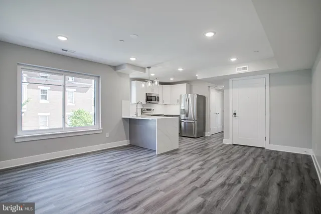 a view of kitchen with wooden floor and window