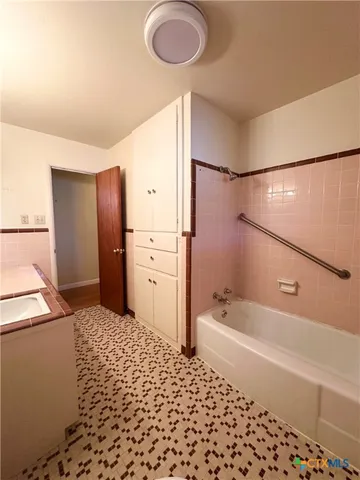 a bathroom with a bathtub and a shower