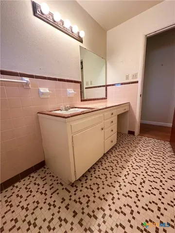 a room with a sink and cabinets