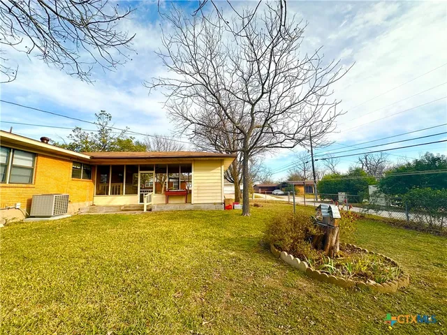 a view of a house with a yard patio and swimming pool