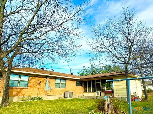 a front view of a house with a yard table and chairs