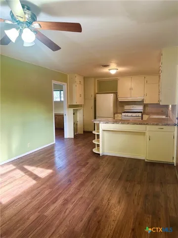 a kitchen with a cabinets and wooden floor