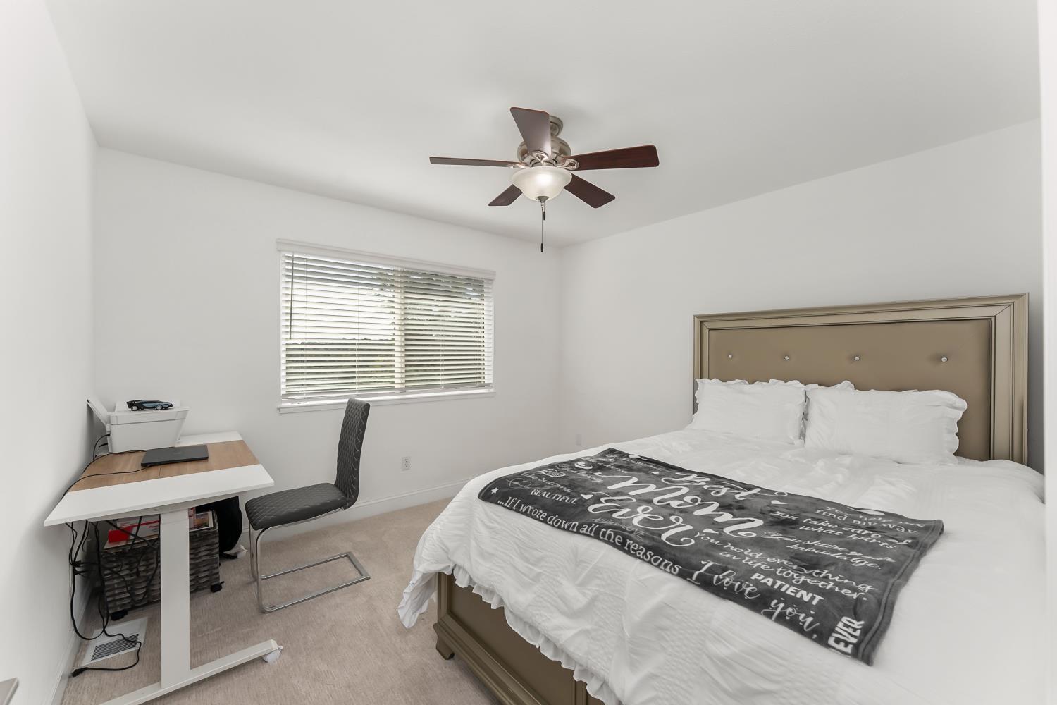 2801 Osborne Road Cameron Park, CA 95682 - Photo 13 of 37 a bedroom with a bed and a table in it with window