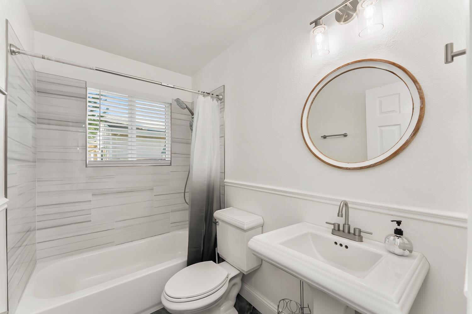 2801 Osborne Road Cameron Park, CA 95682 - Photo 20 of 37 a bathroom with a sink a toilet and a mirror