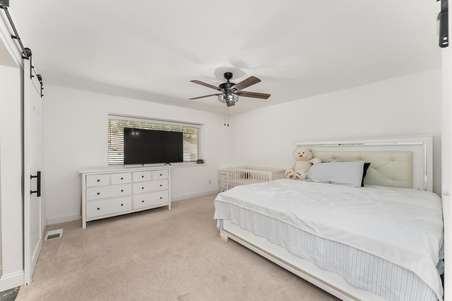2801 Osborne Road Cameron Park, CA 95682 - Photo 9 of 37 a bedroom with a bed a couch and a ceiling fan