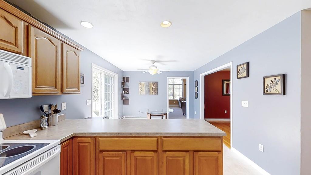 1079 North Brookfield Road Oakham, MA 01068 - Photo 11 of 40 a kitchen with kitchen island granite countertop a sink cabinets and stainless steel appliances