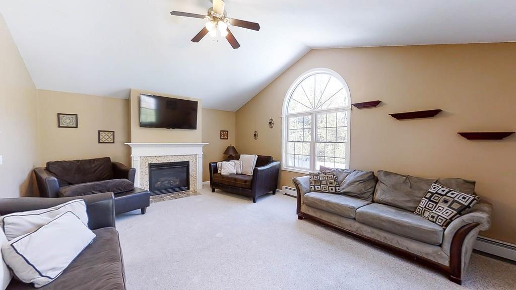 1079 North Brookfield Road Oakham, MA 01068 - Photo 16 of 40 a living room with furniture a fireplace and a flat screen tv