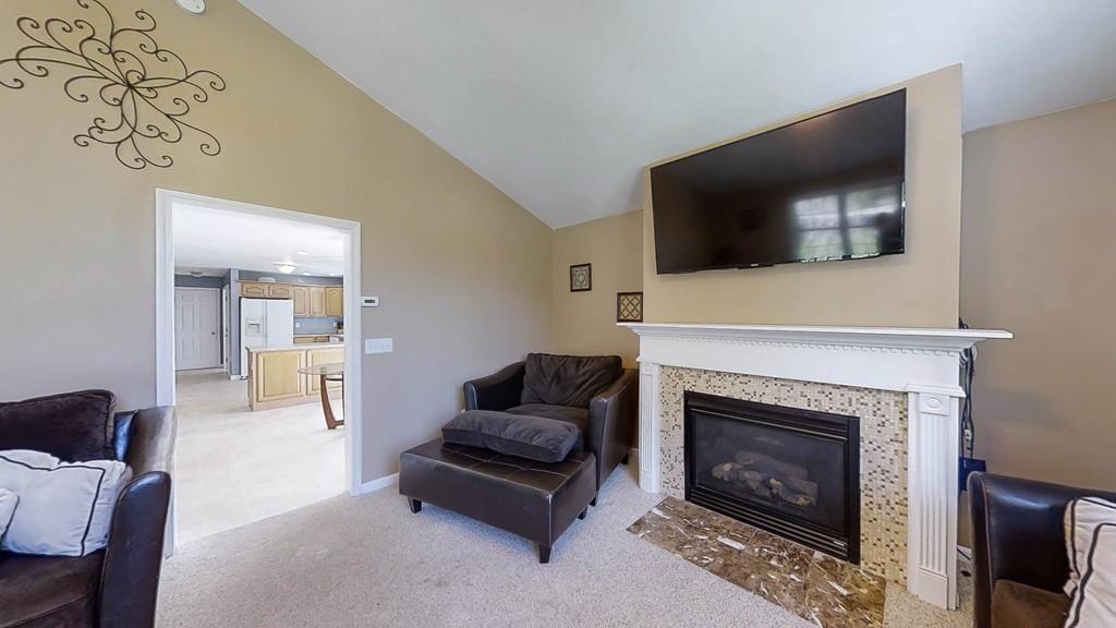 1079 North Brookfield Road Oakham, MA 01068 - Photo 18 of 40 a living room with furniture a flat screen tv and a fireplace